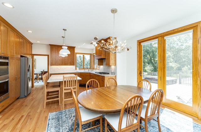 160 River Bluff Pl NW, Cascade Twp, MN 55901 - dining room with recessed lighting, light wood-style floors, and a chandelier