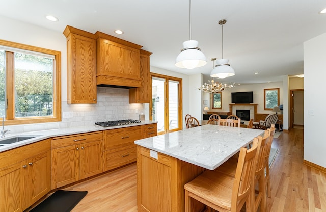 160 River Bluff Pl NW, Cascade Twp, MN 55901 - kitchen with light wood finished floors, tasteful backsplash, a center island, a breakfast bar, and recessed lighting