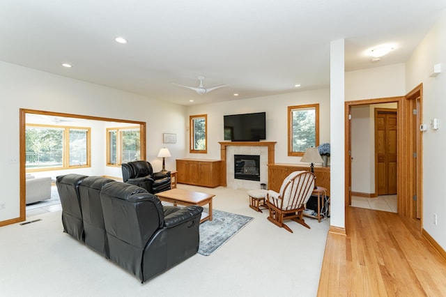 160 River Bluff Pl NW, Cascade Twp, MN 55901 - living area featuring a tiled fireplace, recessed lighting, a ceiling fan, and light wood-type flooring