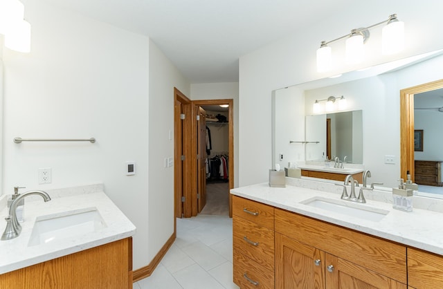 160 River Bluff Pl NW, Cascade Twp, MN 55901 - bathroom with two vanities, tile patterned flooring, and a walk in closet