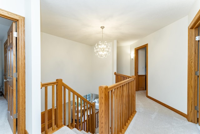 160 River Bluff Pl NW, Cascade Twp, MN 55901 - hallway with an upstairs landing, light carpet, and a chandelier