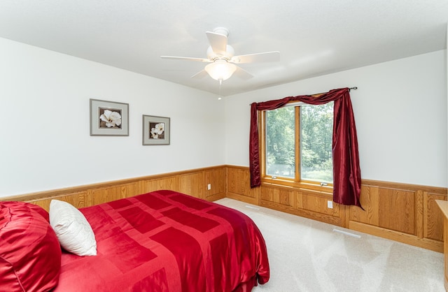 160 River Bluff Pl NW, Cascade Twp, MN 55901 - bedroom featuring wainscoting, wooden walls, carpet, and a ceiling fan