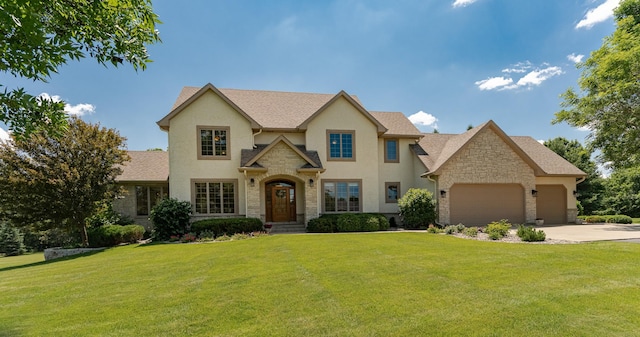 160 River Bluff Pl NW, Cascade Twp, MN 55901 - traditional-style house featuring stone siding, an attached garage, a front yard, and concrete driveway