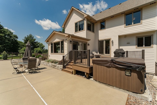160 River Bluff Pl NW, Cascade Twp, MN 55901 - back of house featuring a hot tub, a patio, outdoor dining area, and a shingled roof
