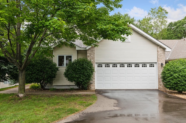 3406 Eagan Oaks Ct, Eagan, MN 55123 - obstructed view of property with asphalt driveway, brick siding, and an attached garage