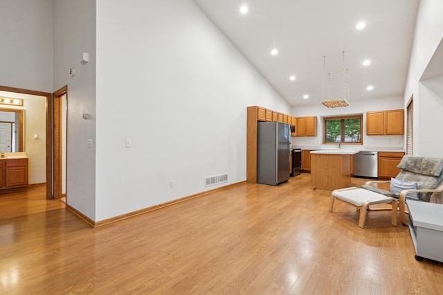 3406 Eagan Oaks Ct, Eagan, MN 55123 - kitchen featuring freestanding refrigerator, high vaulted ceiling, stainless steel dishwasher, light countertops, and a kitchen island