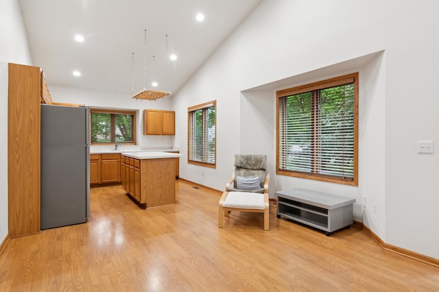 3406 Eagan Oaks Ct, Eagan, MN 55123 - kitchen with freestanding refrigerator, light countertops, a center island, recessed lighting, and light wood-style floors
