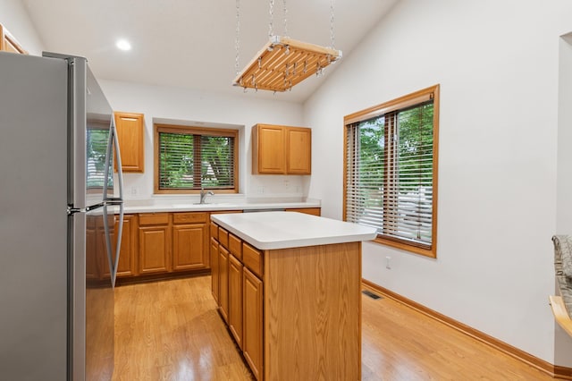 3406 Eagan Oaks Ct, Eagan, MN 55123 - kitchen featuring freestanding refrigerator, light wood-type flooring, light countertops, healthy amount of natural light, and lofted ceiling