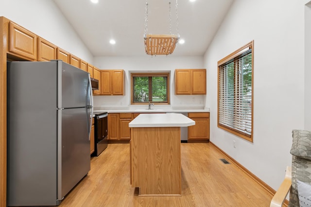 3406 Eagan Oaks Ct, Eagan, MN 55123 - kitchen with stainless steel appliances, light countertops, light wood finished floors, plenty of natural light, and vaulted ceiling