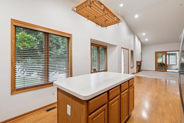 3406 Eagan Oaks Ct, Eagan, MN 55123 - kitchen with light wood-style flooring, a kitchen island, light countertops, recessed lighting, and brown cabinets