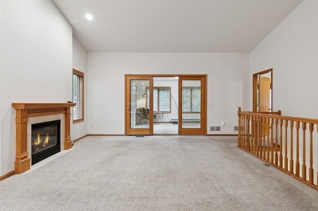 3406 Eagan Oaks Ct, Eagan, MN 55123 - unfurnished living room with carpet flooring, a glass covered fireplace, recessed lighting, and a baseboard heating unit