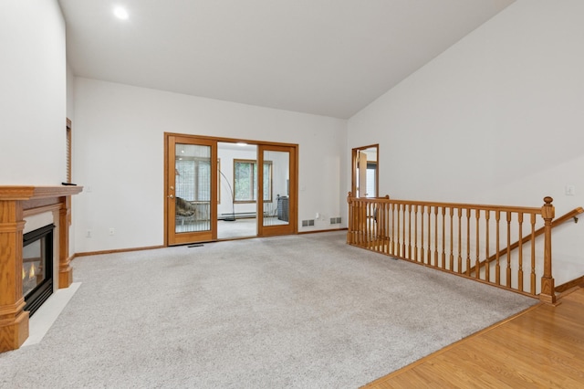 3406 Eagan Oaks Ct, Eagan, MN 55123 - unfurnished living room with a fireplace with flush hearth, wood finished floors, and vaulted ceiling