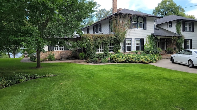 3307 Nokomis NE, Alexandria, MN 56308 - view of front of property with a chimney, a front lawn, and brick siding