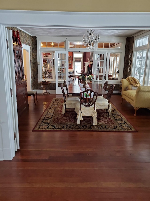 3307 Nokomis NE, Alexandria, MN 56308 - dining room featuring plenty of natural light, wood finished floors, and a chandelier