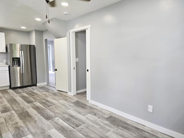 1204 10th St NE, Austin, MN 55912 - kitchen featuring stainless steel fridge, recessed lighting, light wood finished floors, and white cabinets