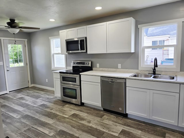 1204 10th St NE, Austin, MN 55912 - kitchen featuring stainless steel appliances, a ceiling fan, white cabinetry, and recessed lighting