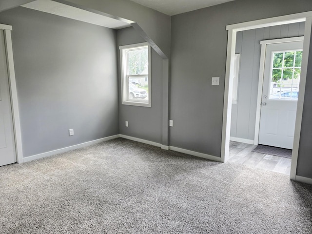 1204 10th St NE, Austin, MN 55912 - unfurnished bedroom with carpet flooring and arched walkways