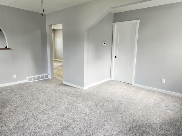 1204 10th St NE, Austin, MN 55912 - spare room featuring carpet flooring and baseboards