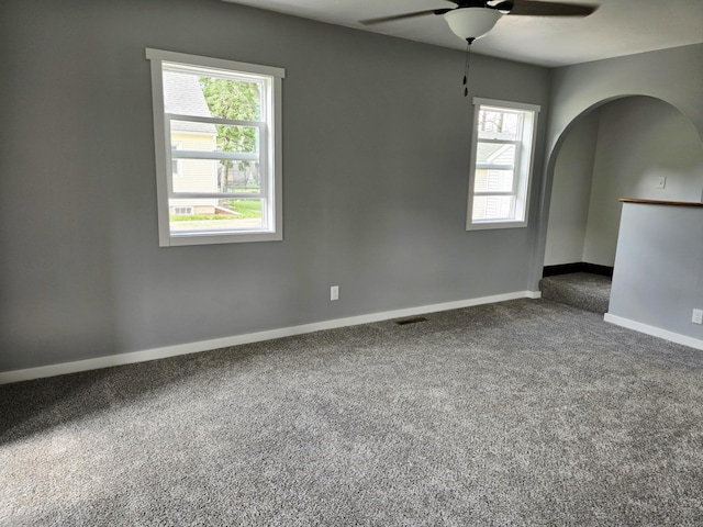 1204 10th St NE, Austin, MN 55912 - carpeted spare room with a ceiling fan and arched walkways