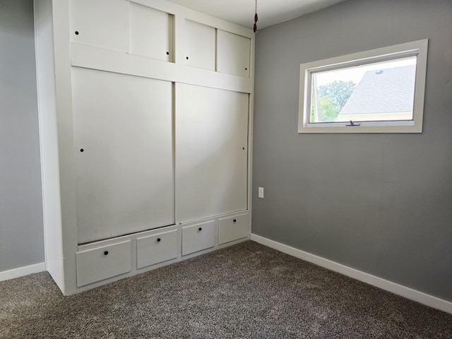 1204 10th St NE, Austin, MN 55912 - unfurnished bedroom with dark carpet and a closet