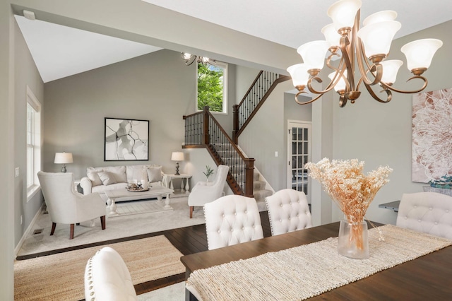 3153 Magnolia Dr, Medina, MN 55340 - dining space with a chandelier, wood finished floors, high vaulted ceiling, and stairway