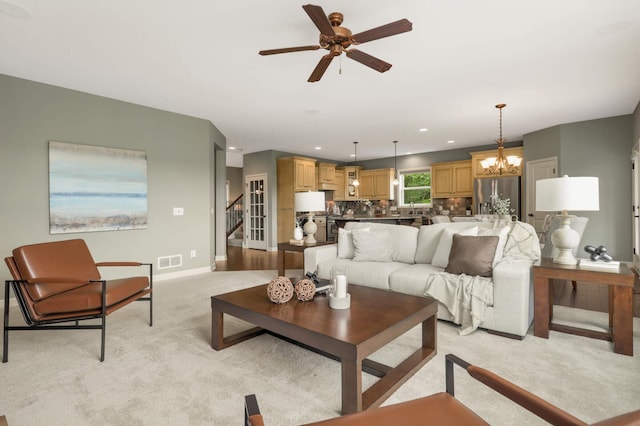 3153 Magnolia Dr, Medina, MN 55340 - living room with light carpet, ceiling fan, a chandelier, stairway, and recessed lighting