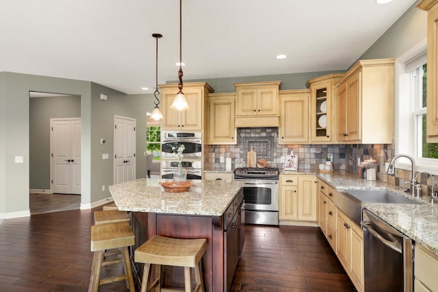 3153 Magnolia Dr, Medina, MN 55340 - kitchen featuring appliances with stainless steel finishes, dark wood-type flooring, tasteful backsplash, and recessed lighting