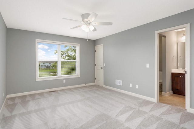 3153 Magnolia Dr, Medina, MN 55340 - unfurnished bedroom featuring light colored carpet, connected bathroom, and ceiling fan