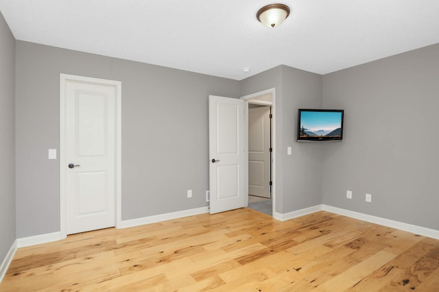 3153 Magnolia Dr, Medina, MN 55340 - unfurnished bedroom featuring light wood-type flooring and baseboards