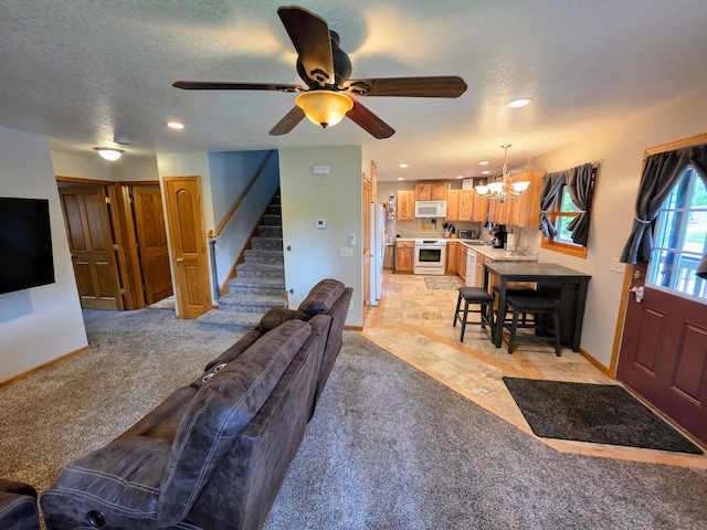 825 2nd Ave, Grand Rapids, MN 55744 - living room with a chandelier, stairs, recessed lighting, ceiling fan, and light colored carpet