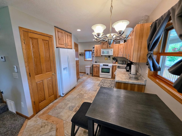 825 2nd Ave, Grand Rapids, MN 55744 - kitchen with white appliances, a chandelier, light countertops, hanging light fixtures, and recessed lighting