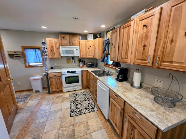825 2nd Ave, Grand Rapids, MN 55744 - kitchen featuring white appliances, recessed lighting, light stone finish flooring, and brown cabinets
