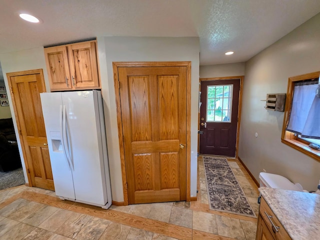 825 2nd Ave, Grand Rapids, MN 55744 - kitchen with white fridge with ice dispenser, recessed lighting, light countertops, and a textured ceiling