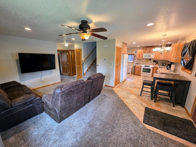 825 2nd Ave, Grand Rapids, MN 55744 - living area with a chandelier, stairs, recessed lighting, ceiling fan, and a textured ceiling