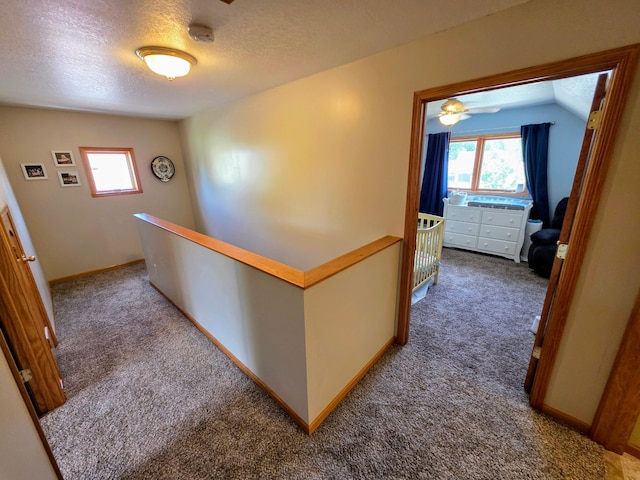 825 2nd Ave, Grand Rapids, MN 55744 - hall featuring an upstairs landing, carpet flooring, and a textured ceiling