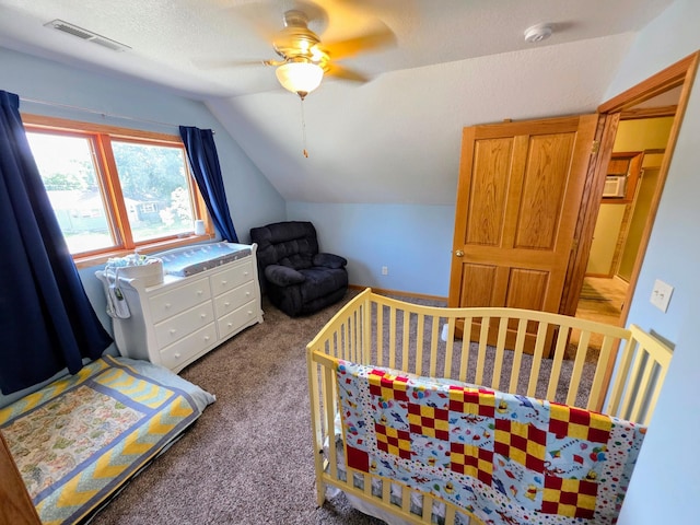 825 2nd Ave, Grand Rapids, MN 55744 - bedroom with lofted ceiling, carpet flooring, a nursery area, and a ceiling fan