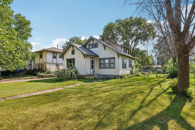 116 3rd Ave SE, Osseo, MN 55369 - view of front facade featuring stucco siding and a chimney