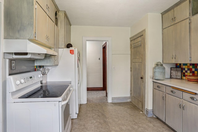 116 3rd Ave SE, Osseo, MN 55369 - kitchen featuring electric stove, under cabinet range hood, light countertops, backsplash, and light tile patterned flooring