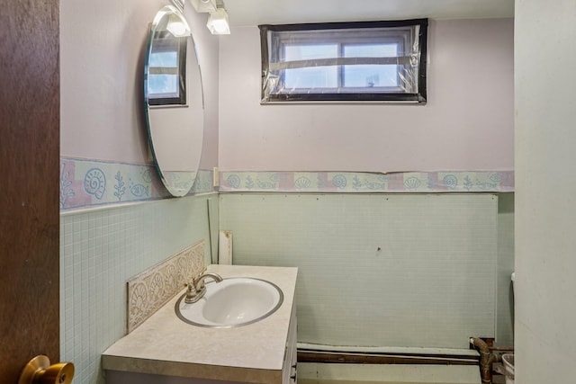 116 3rd Ave SE, Osseo, MN 55369 - half bath with vanity, tile walls, and wainscoting