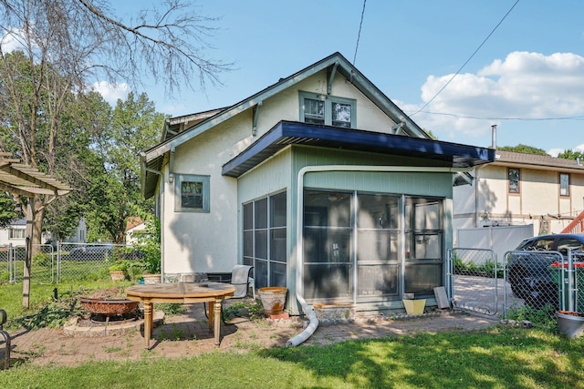 116 3rd Ave SE, Osseo, MN 55369 - back of property featuring a sunroom, a gate, and stucco siding