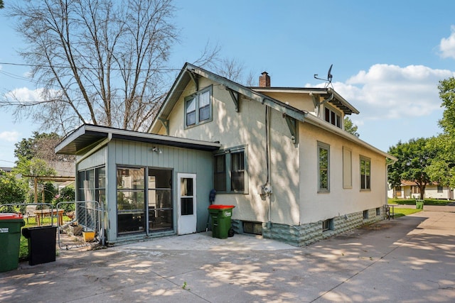 116 3rd Ave SE, Osseo, MN 55369 - back of property with a chimney and a patio area