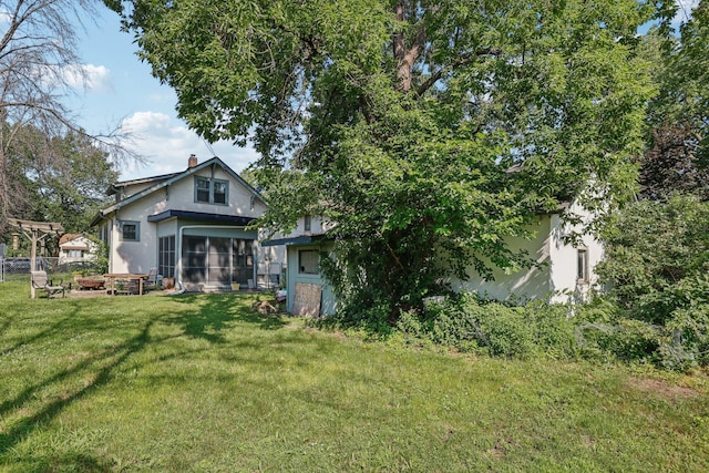 116 3rd Ave SE, Osseo, MN 55369 - back of house with stucco siding, a sunroom, and a chimney