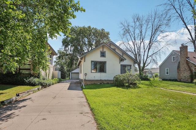 116 3rd Ave SE, Osseo, MN 55369 - bungalow featuring a detached garage, an outbuilding, a front lawn, and stucco siding
