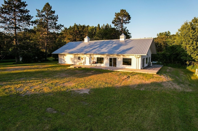 1650 Gunn Rd, Grand Rapids, MN 55744 - rear view of house with a chimney, a yard, a metal roof, and board and batten siding
