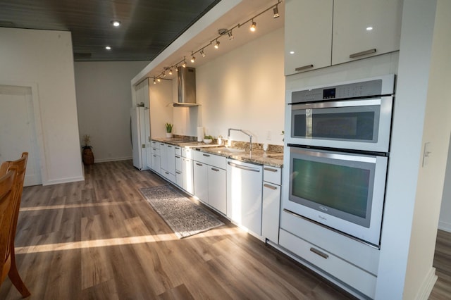 1650 Gunn Rd, Grand Rapids, MN 55744 - kitchen featuring white appliances, wall chimney range hood, wood finished floors, white cabinetry, and light stone counters