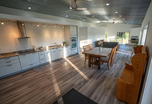 1650 Gunn Rd, Grand Rapids, MN 55744 - kitchen featuring white cabinets, dishwasher, black electric cooktop, stainless steel double oven, and wall chimney exhaust hood