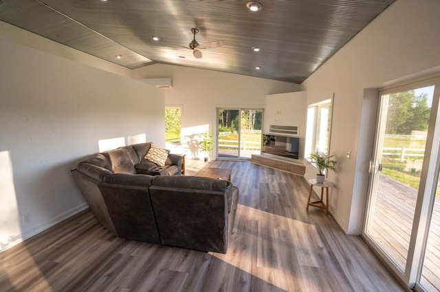 1650 Gunn Rd, Grand Rapids, MN 55744 - living room with vaulted ceiling, healthy amount of natural light, wood finished floors, a glass covered fireplace, and ceiling fan