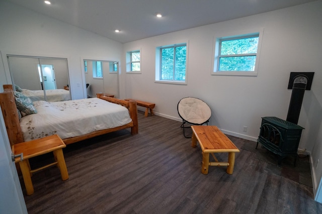 1650 Gunn Rd, Grand Rapids, MN 55744 - bedroom featuring a wood stove, multiple windows, wood finished floors, recessed lighting, and lofted ceiling