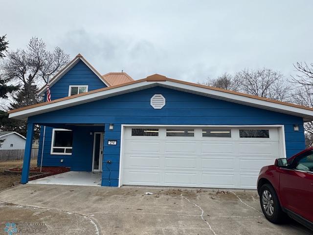 214 7th St, Hatton, ND 58240 - view of front facade with concrete driveway and a garage