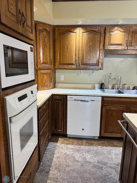 214 7th St, Hatton, ND 58240 - kitchen with white appliances, light countertops, and brown cabinets
